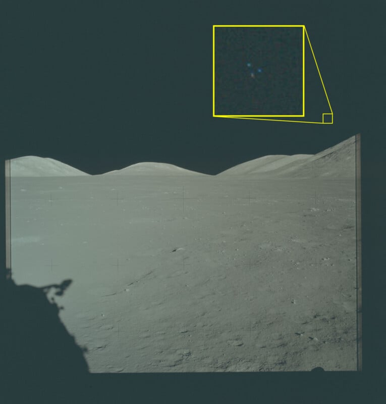 A barren, rocky lunar landscape under a dark sky. A highlighted box in the upper right shows a zoomed-in view of a small, faint blue dot in the sky, contrasting with the moon’s surface below.