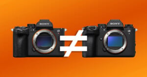 Two Sony Alpha cameras are shown side by side on an orange background, separated by a large "not equal to" symbol, indicating a comparison or difference between the two models.
