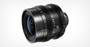 A black camera lens with yellow measurement markings and textured focus and aperture rings, displayed against a plain white background.