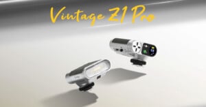 Two metallic camera flash units labeled "Vintage Z1 Pro" are displayed, featuring digital screens and control dials, with a stylish, modern-retro design and yellow text above reading "Vintage Z1 Pro.