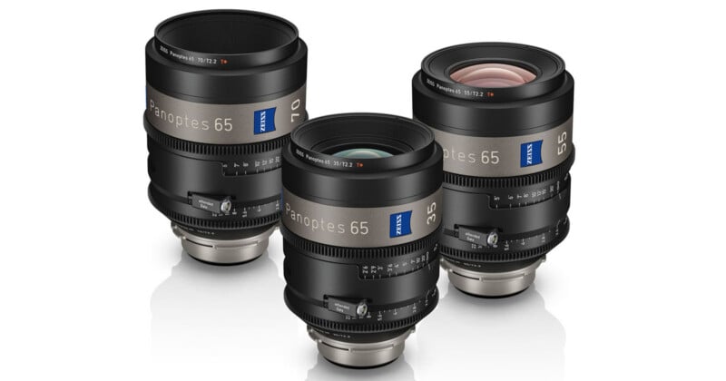 Three professional Zeiss camera lenses are shown standing upright on a white background, displaying their markings, focus rings, and branding, with different focal lengths visible on each lens.