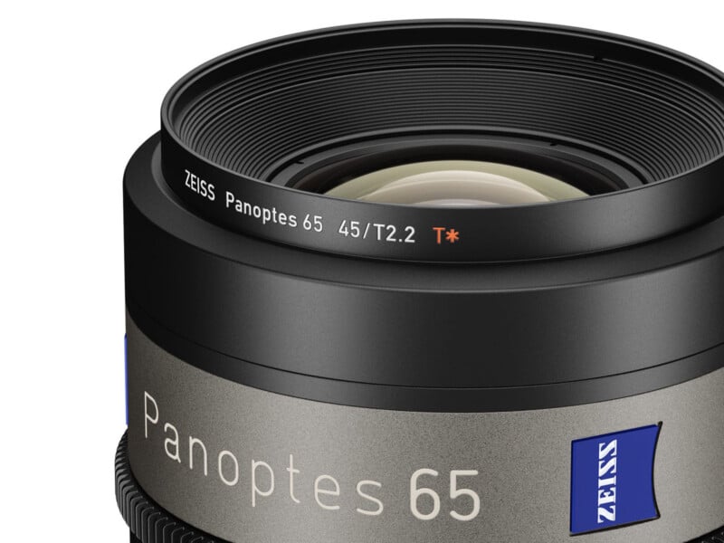 Close-up of a ZEISS Panoptes 65 camera lens with "45/T2.2" marked on the lens rim and a blue ZEISS logo on the side. The lens is black with a metallic finish.