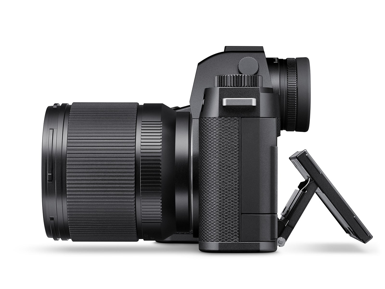 A digital camera with a large lens is shown from the side. The camera’s LCD screen is flipped out and tilted downward, and the grip features a textured surface for holding.