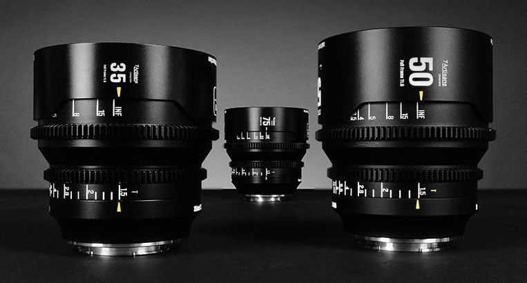 Three professional camera lenses, labeled 35mm, 50mm, and 85mm, are displayed on a dark surface with dramatic lighting, emphasizing their sleek black design and detailed focus markings.