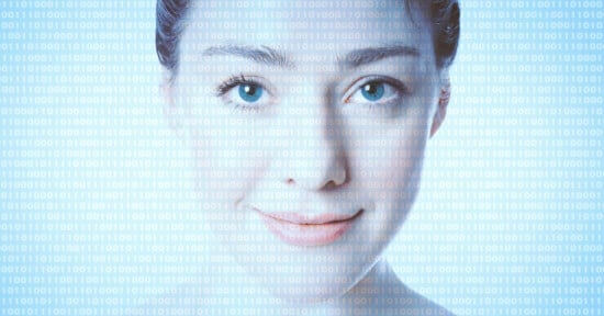 A woman with light skin and blue eyes smiles gently at the camera. Over her face, translucent binary code (ones and zeros) is displayed, symbolizing the intersection of humans and digital technology.