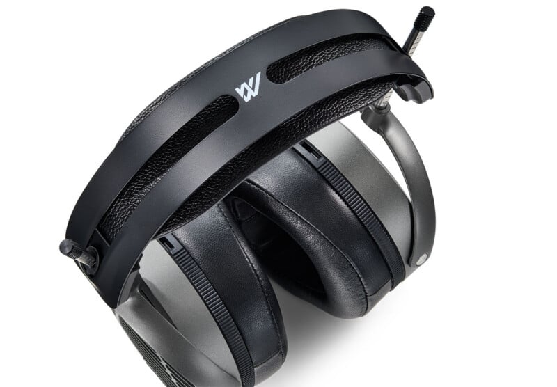 A pair of over-ear headphones with a black, cushioned headband and large, padded ear cups. The headband features a white "W" logo and a dual-band design. The headphones are positioned at an angle.