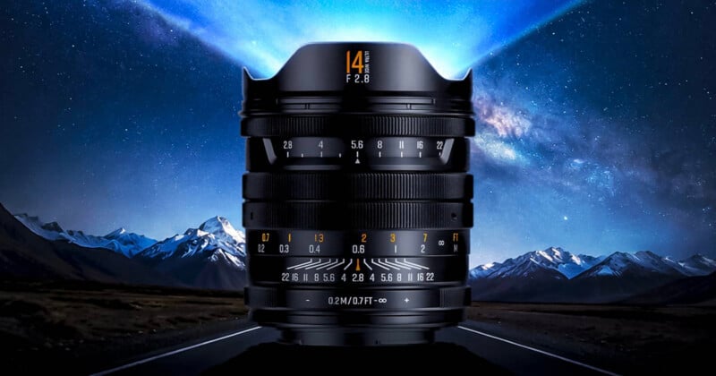 A wide-angle camera lens stands upright on a road, with snow-capped mountains and a starry night sky in the background, creating a dramatic and futuristic effect.