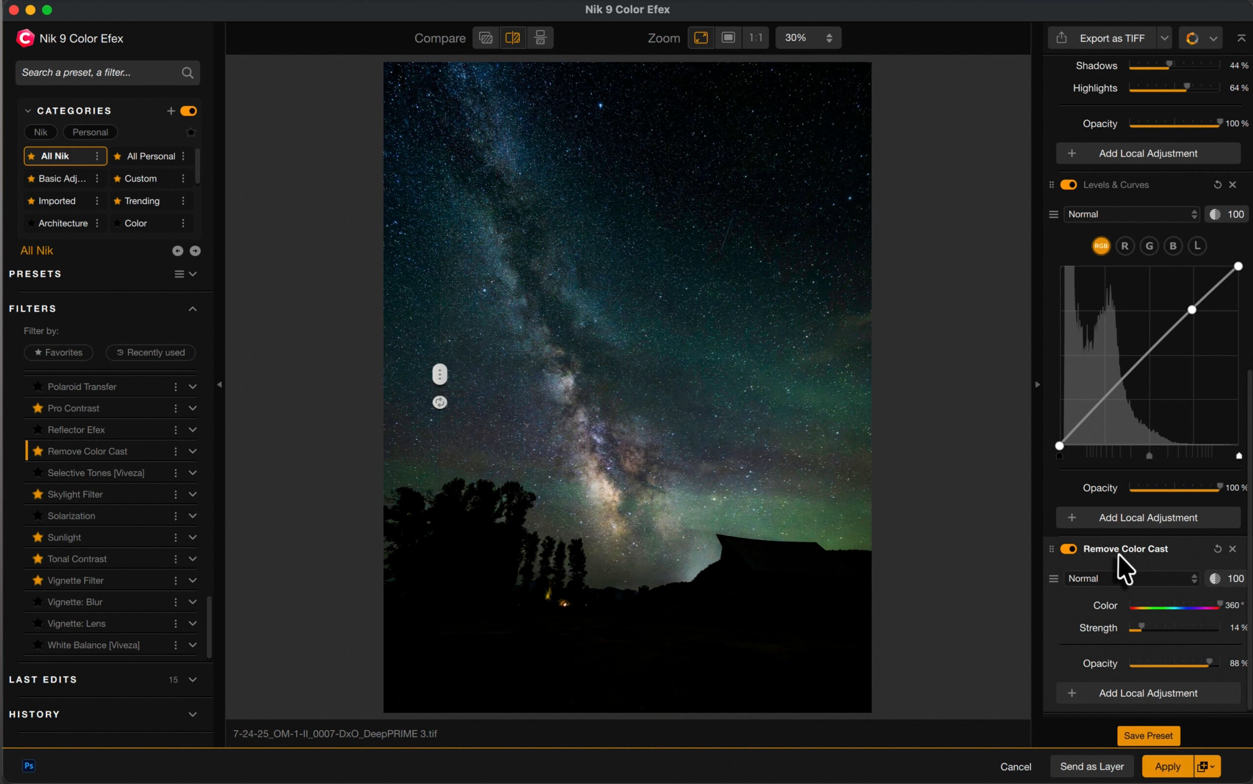 A computer screen displays photo editing software with an image of the Milky Way above a dark landscape. Editing tools and color adjustment options are open on the right side of the screen.
