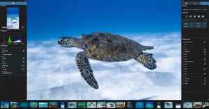 A screenshot of a photo editing software displaying an underwater image of a sea turtle swimming above a sandy ocean floor, with editing tools and photo thumbnails visible on the screen.