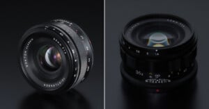 Side-by-side photo of two Voigtländer NOKTON classic 35mm camera lenses on a black surface, showing different angles and highlighting the aperture and focus markings.