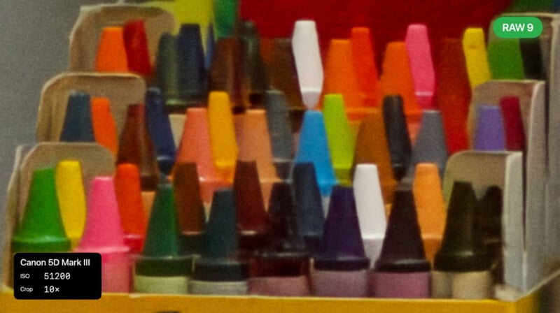 A close-up photo of colorful crayon boxes with crayons arranged upright. The image is slightly grainy and blurred. Overlay labels indicate camera settings: Canon 5D Mark III, ISO 51200, RAW 9, Crop 10x.