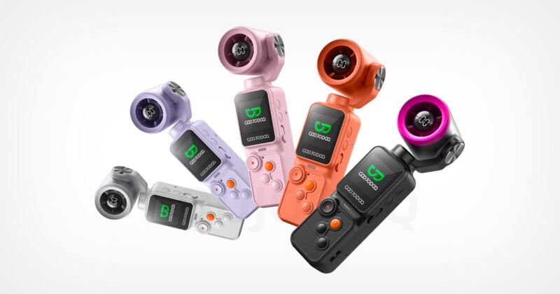 Seven handheld action cameras in various colors (black, pink, purple, orange, and silver) stand upright and tilted, displaying their screens and lens assemblies, against a white background.