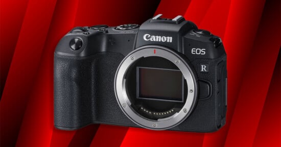 A Canon EOS mirrorless camera body without a lens is shown against a red, diagonally striped background. The camera sensor and lens mount are clearly visible.