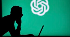A silhouette of a person using a laptop, with the OpenAI logo displayed on a green background behind them.