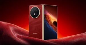 A luxurious smartphone with a red leather back and gold accents stands upright on a matching red surface. The screen displays a vivid space-themed wallpaper with a planet and glowing light. The brand "HONOR" is visible on the back.