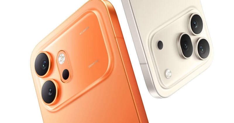 Close-up of the backs of two smartphones, one orange and one white, each featuring two or three rear cameras and an LED flash within raised rectangular camera modules.