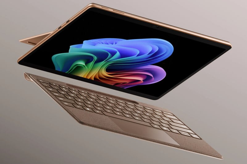 A tablet with a colorful screen and a detachable keyboard floats in midair against a neutral background, suggesting flexibility and versatility in its use.