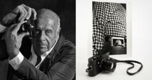 Black-and-white photo showing an older man holding a camera to his eye on the left, and on the right, a camera in front of a photo of a person in a checkered shirt with a photo tucked into their waistband.