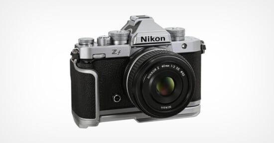A Nikon Z f mirrorless digital camera with a retro silver and black design, shown with a NIKKOR Z 40mm f/2 SE lens attached, against a plain white background.