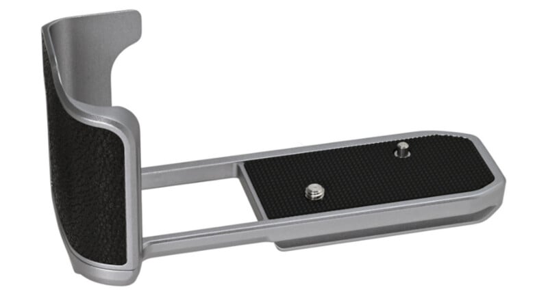 A silver and black metal camera grip attachment with a textured surface, designed to be mounted on the bottom of a camera for improved handling and stability.