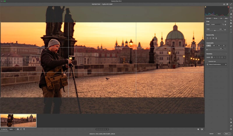 A person stands on a cobblestone bridge at sunrise, adjusting a camera on a tripod. Historic buildings and domes are visible in the background under an orange sky, with the scene displayed on a computer editing screen.