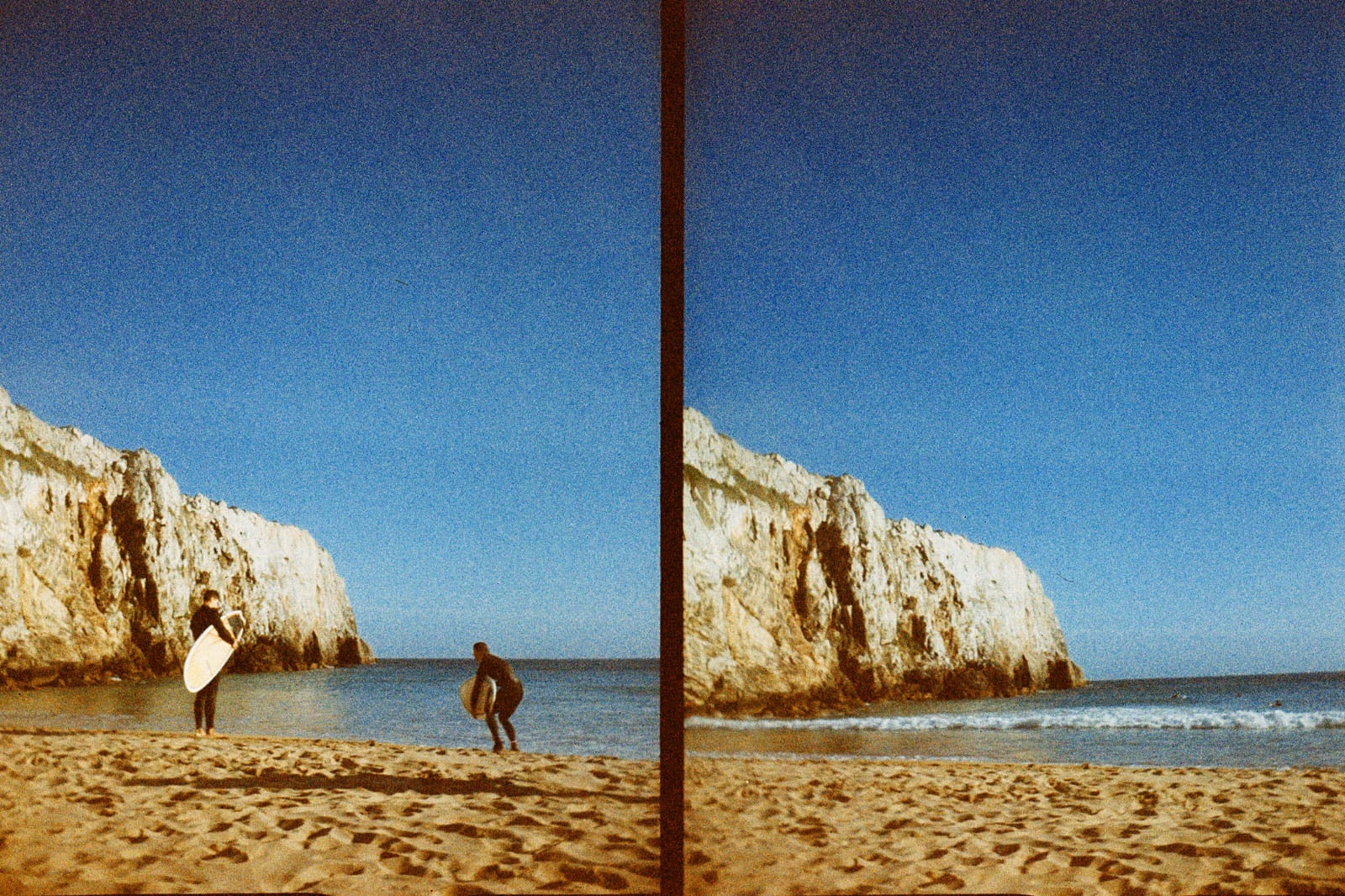 A split image of a sandy beach with large cliffs, blue sky, and two surfers: one walking with a surfboard, the other heading toward the water.