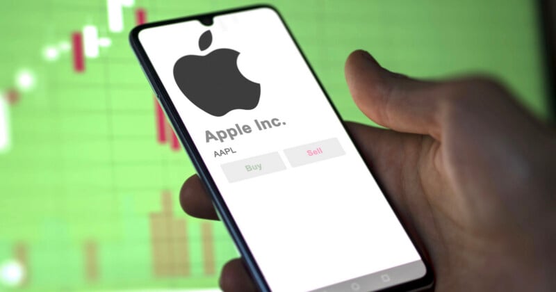 A hand holds a smartphone displaying the Apple Inc. logo and stock info, with "Buy" and "Sell" buttons. A blurred stock chart appears in the green background.