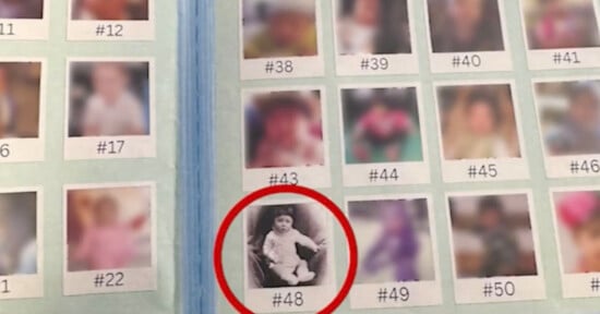 A photo album page displays several small, blurred portraits labeled with numbers. One black-and-white baby photo, labeled #48, is circled in red, drawing attention to it among the surrounding color images.