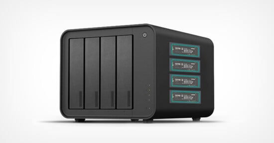 A black network attached storage (NAS) device with four vertical drive bays on the left and four panels with digital displays on the right, set against a plain white background.