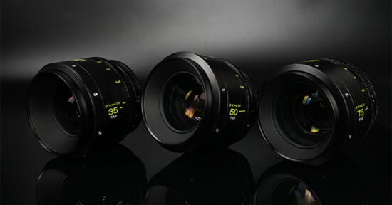 Three camera lenses labeled 35mm, 50mm, and 85mm are arranged side by side on a reflective black surface with a dark, softly lit background.