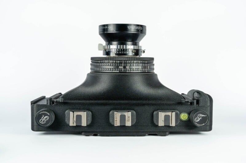 A black panoramic film camera with a Rodenstock Grandagon lens, viewed from the top, featuring two film advance knobs labeled R and F, a spirit level, and a central plate marked CCB 617C 0130.
