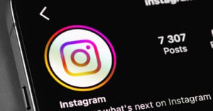 A close-up of a smartphone screen displaying the Instagram profile page, showing the app logo, the word "Instagram," and "7 307 Posts.