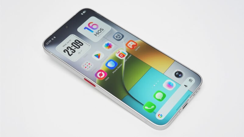 A silver smartphone with a flat-edge design sits at an angle on a white surface, displaying a home screen with a clock widget and various app icons.