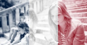 A young woman sits on outdoor steps looking at her phone, with a faded French flag overlay on the image. Other people are seated in the background, blurred and engaged with their own devices.