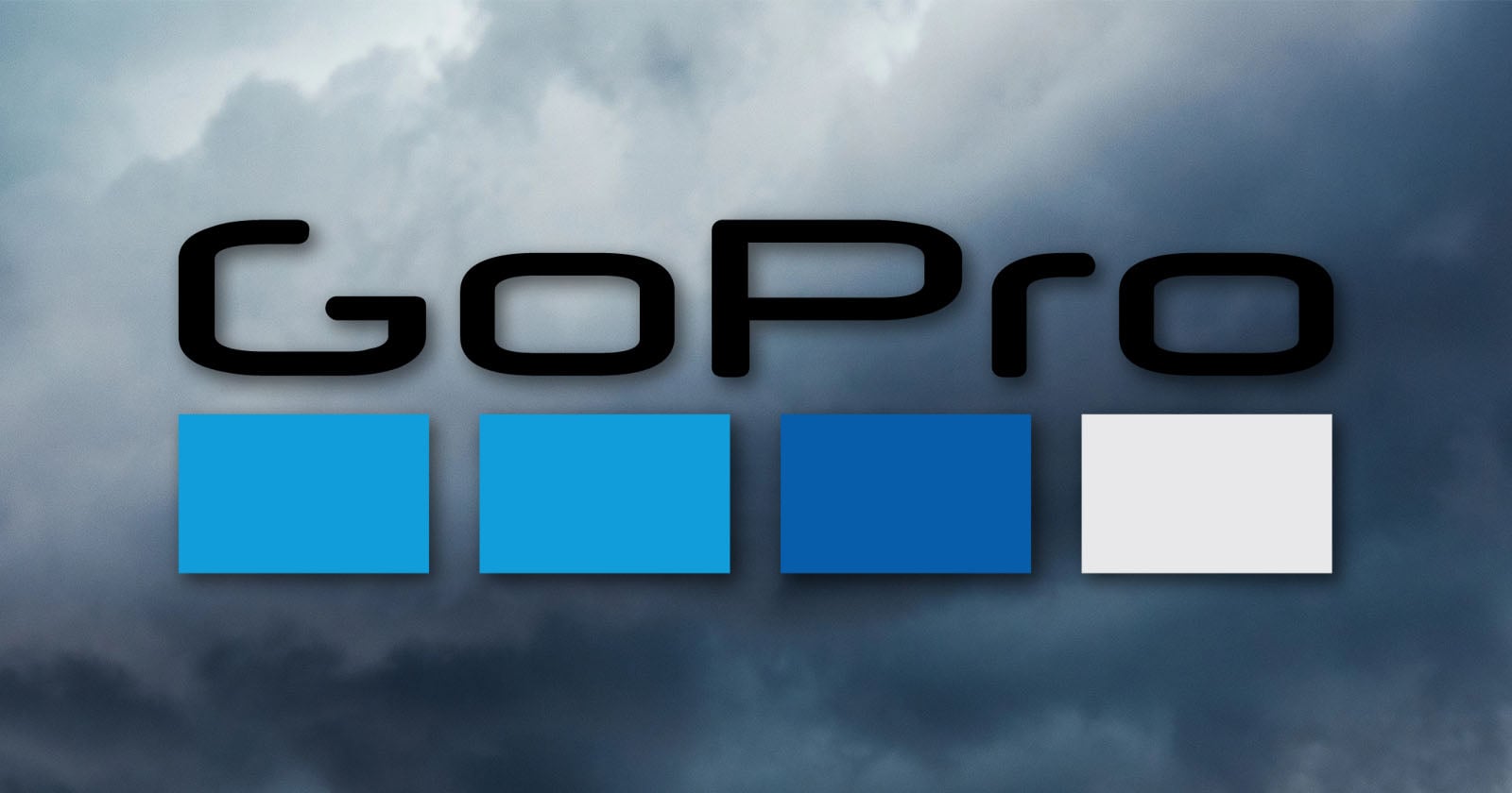The GoPro logo with four squares in light blue, blue, dark blue, and gray on a cloudy sky background.