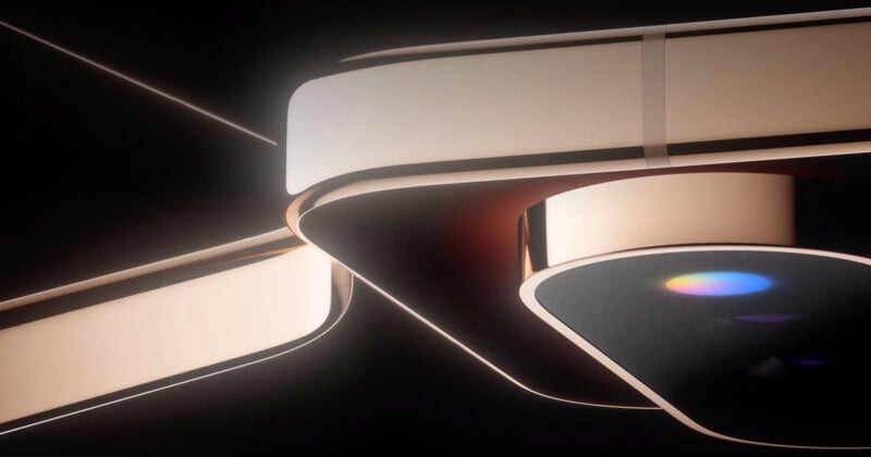 A close-up of a sleek, modern device with smooth, curved surfaces and soft lighting, featuring a colorful lens or reflective surface in the center. The design appears futuristic and minimalistic.