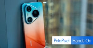 Huawei smartphone with a gradient red-to-blue back and triple camera setup leans against a window; "PetaPixel Hands-On" text overlay appears in the bottom right.