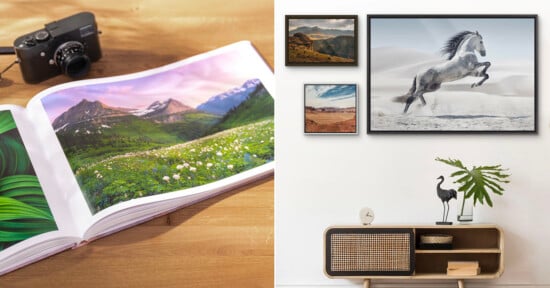 A photo book with landscape images lies open on a wooden table beside a camera. Nearby, framed nature and horse photos hang above a modern sideboard with decor items, including a plant and a bird sculpture.