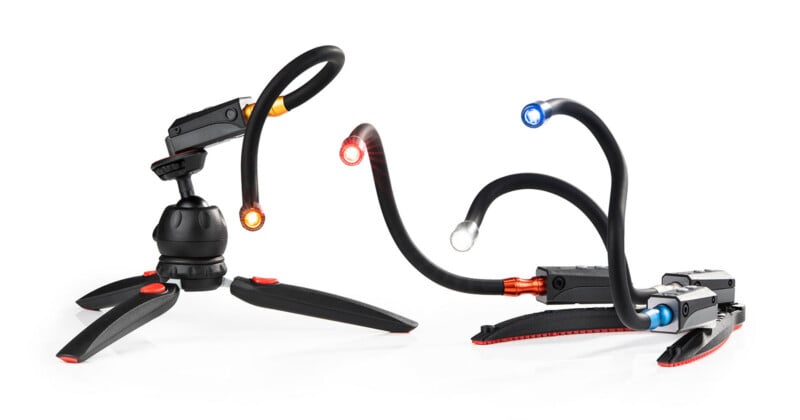 Two flexible, multi-armed LED task lights stand on a white surface, one mounted on a tripod base and the other on a flat base.