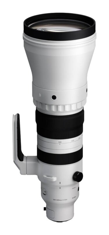 A white telephoto zoom lens with a black rubber grip, a side handle, and markings indicating a 300-600mm focal range.