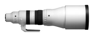 A side view of a large white telephoto zoom lens with a black rubber grip and a tripod mounting foot, set against a white background.