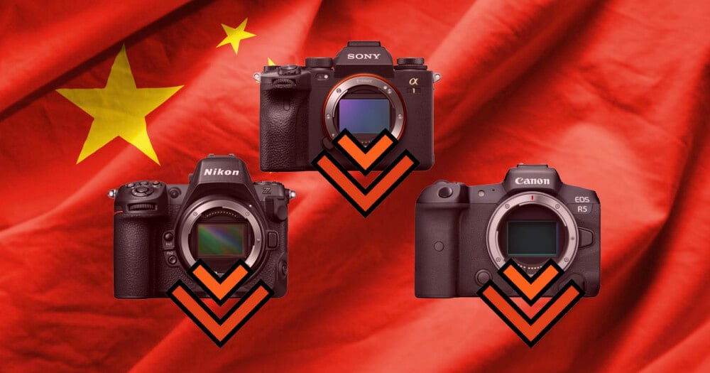 Three digital cameras are arranged in a triangle over a red flag with yellow stars, each featuring a downward-pointing orange chevron.