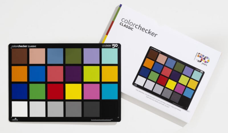 A Calibrite ColorChecker Classic target sits next to its white product packaging on a plain white surface.
