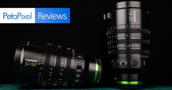Two Fujinon cinema zoom lenses, one lying horizontally and one standing vertically, are displayed against a black background with a PetaPixel Reviews logo in the top left.
