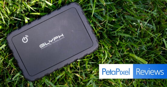 A black Glyph Production Technologies external hard drive rests on green grass, with a PetaPixel Reviews logo in the corner.