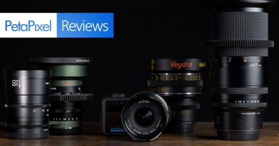 A collection of various camera lenses and a GoPro camera sit on a wooden surface against a black background, with a PetaPixel Reviews logo in the top left corner.