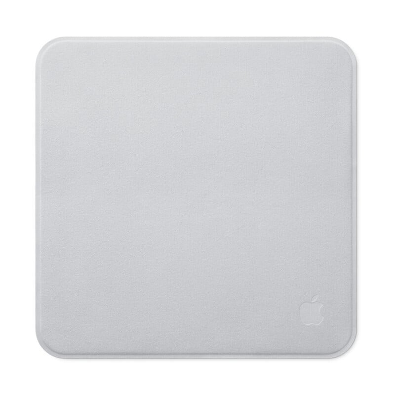 A square, light gray microfiber cleaning cloth with a small, embossed Apple logo in the bottom right corner, set against a white background.