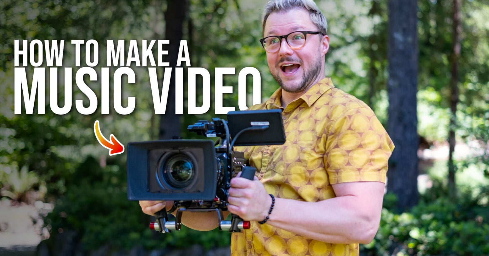 A man with glasses and a yellow patterned shirt holds a professional video camera in a wooded area, with the text "HOW TO MAKE A MUSIC VIDEO" overlaid.