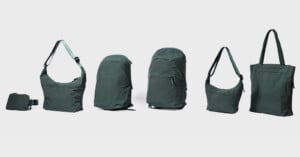 A lineup of six dark green bags, including a small waist pack, two shoulder bags, two backpacks, and a tote bag, arranged against a light gray background.