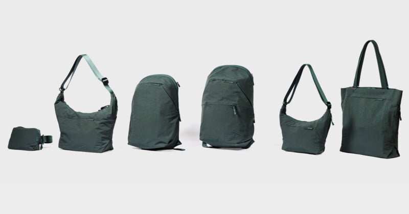 A lineup of six dark green bags, including a small waist pack, two shoulder bags, two backpacks, and a tote bag, arranged against a light gray background.